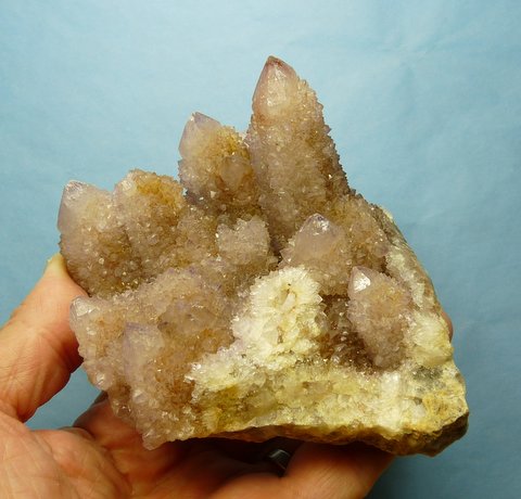 Group of pale amethyst coloured cactus quartz crystals on quartz matrix