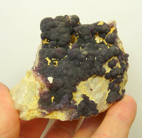 Deep purple, botryoidal fluorite crystals on feldspar matrix