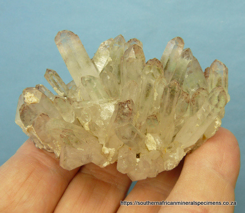 Quartz crystal group with chlorite inclusions and hematite
