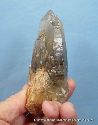 Smoky quartz crystal with parts having cathedral growth patterns