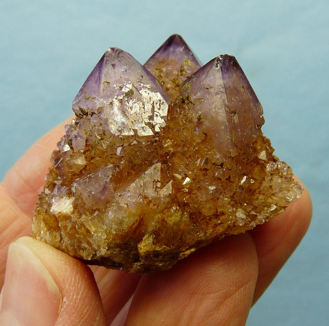 Light amethyst cactus quartz crystal group with iron oxide colouring, on matrix