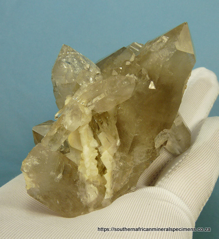Light smoky quartz crystal group with rutile and feldspar