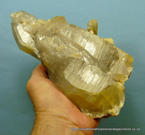 Quartz crystal group with feldspar and bits of rutile