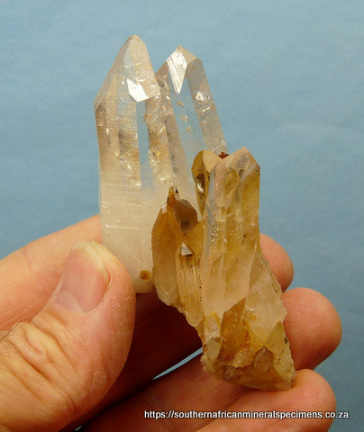 A piece of light smoky quartz with copper coloured rutile needles